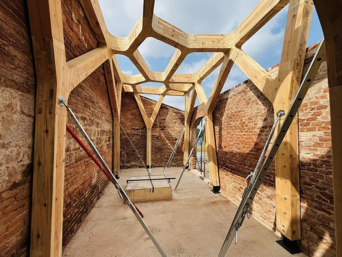 Vault braced during erection inside the reused shell.