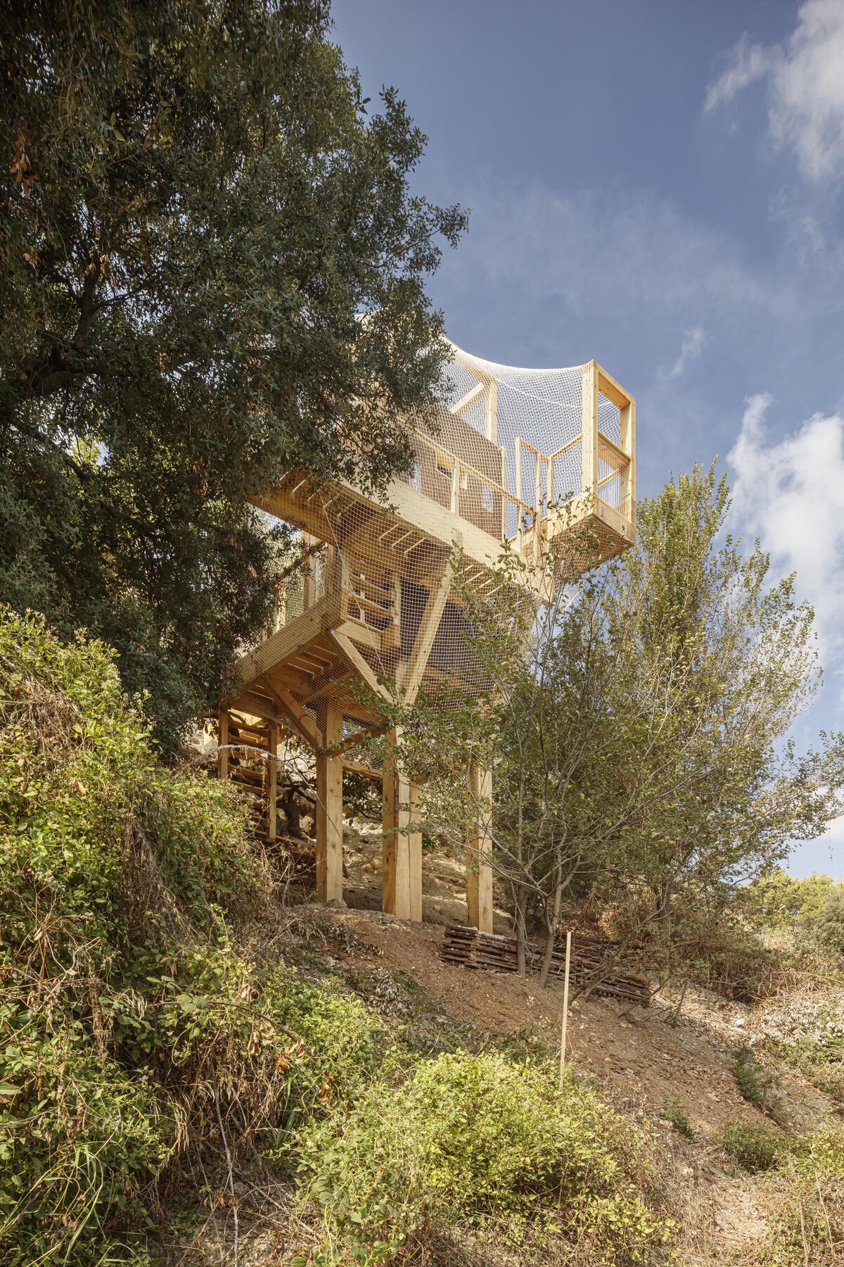 Three elevated walkways wrapping the observation core.