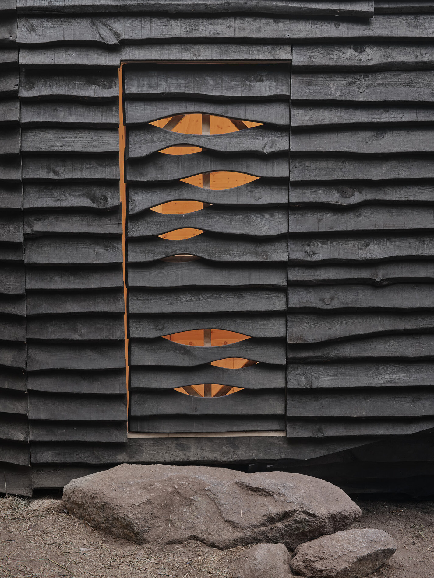 Charred cladding, with the door cut through it.