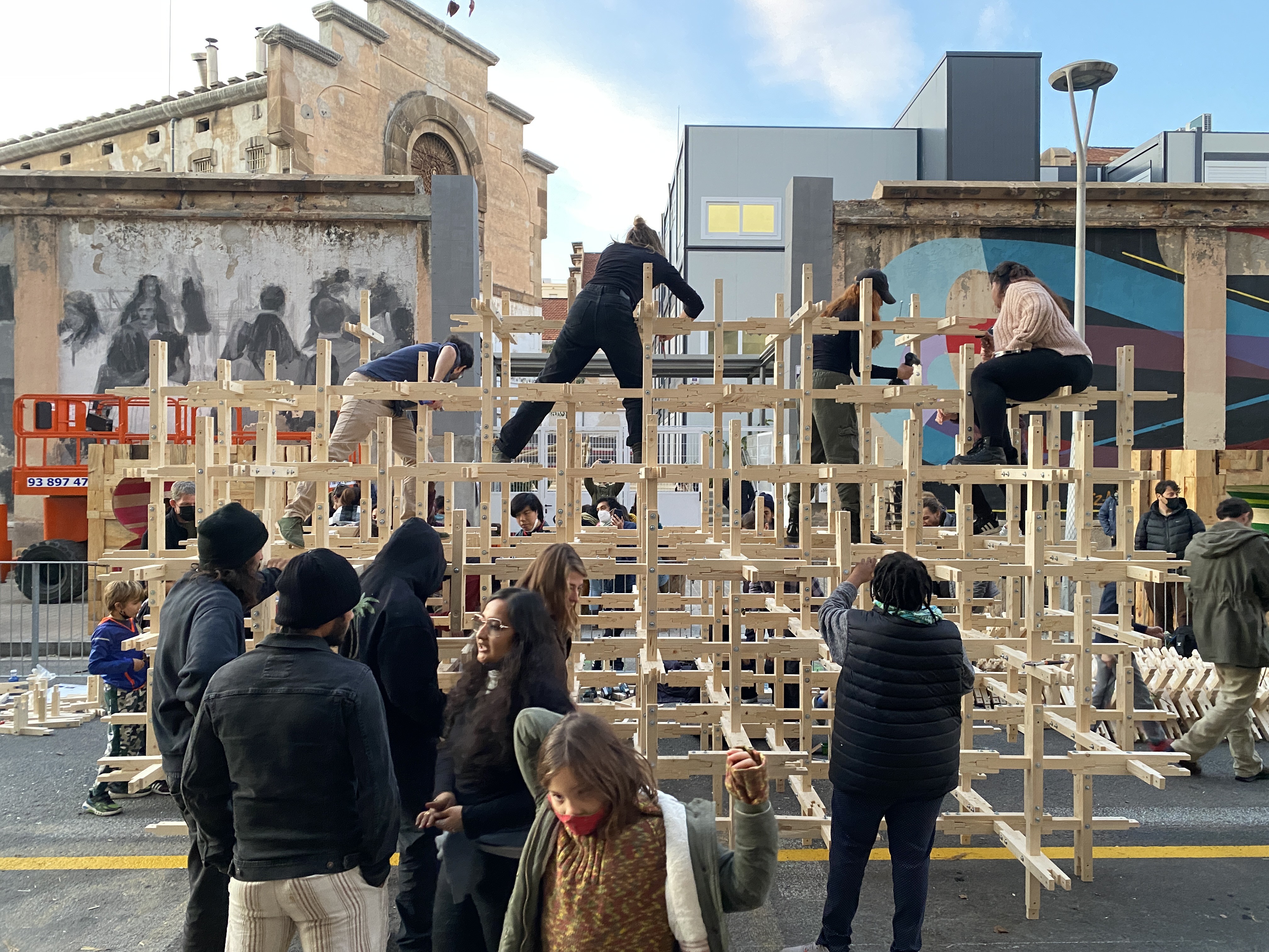 IAAC master's students climb into the New Niu to fasten the lattice joints before installation.