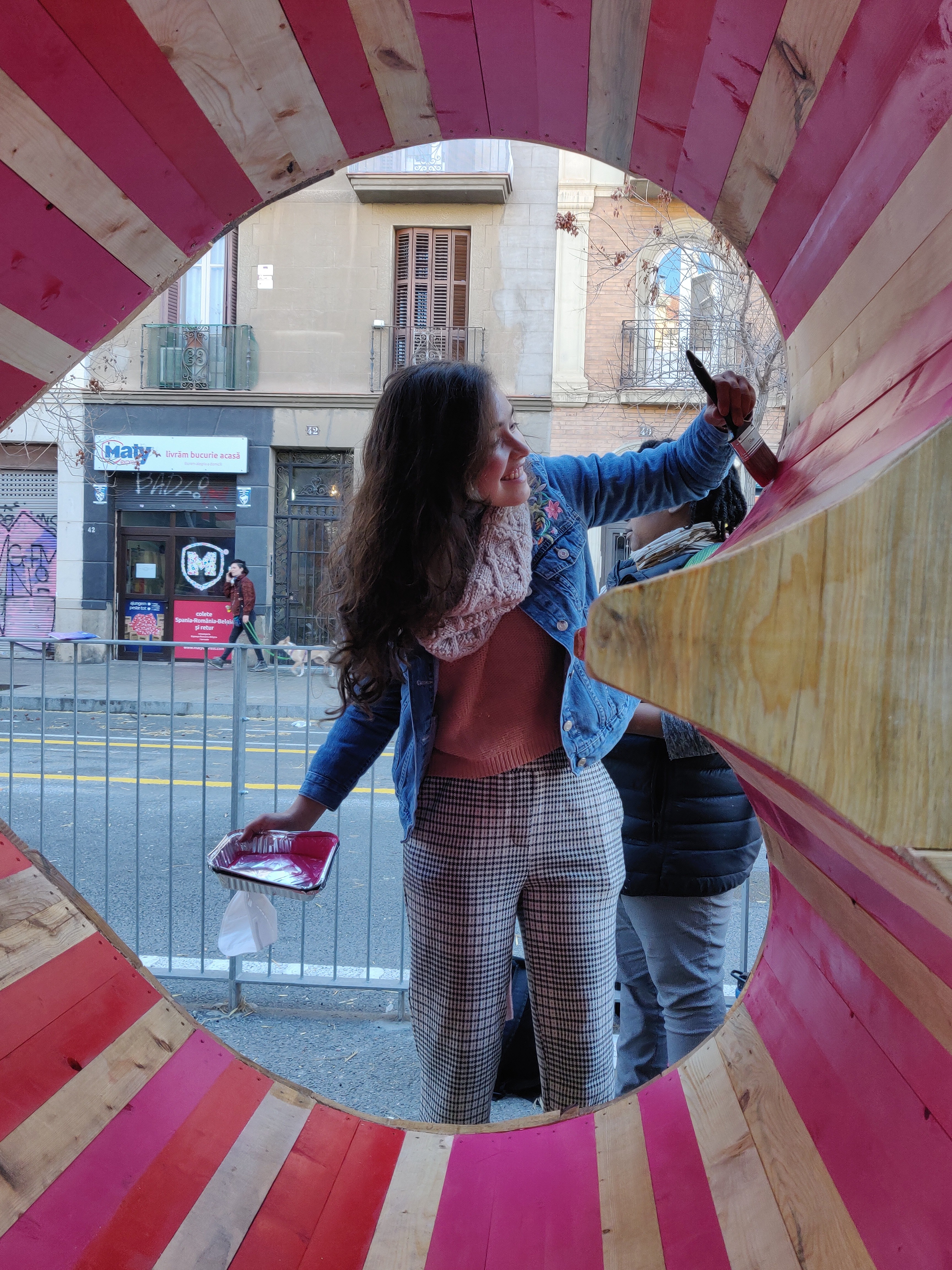 Touching up the paint of the heart-shaped porthole, cut through packed wood offcuts.