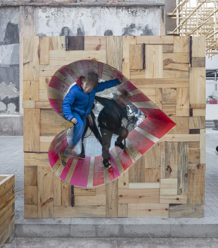Additional FURNISH xKIC elements by IAAC at Escola Entença include occupiable waste-wood frames for interpretive play.