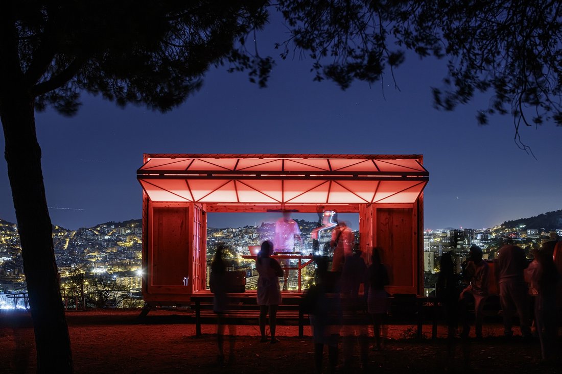 Illuminated from within, the lights of the city beyond.