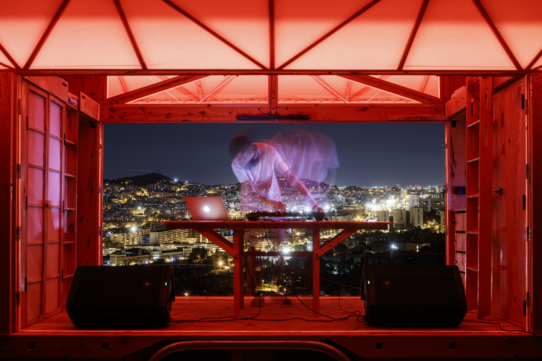 The DJ booth at night, above Barcelona.