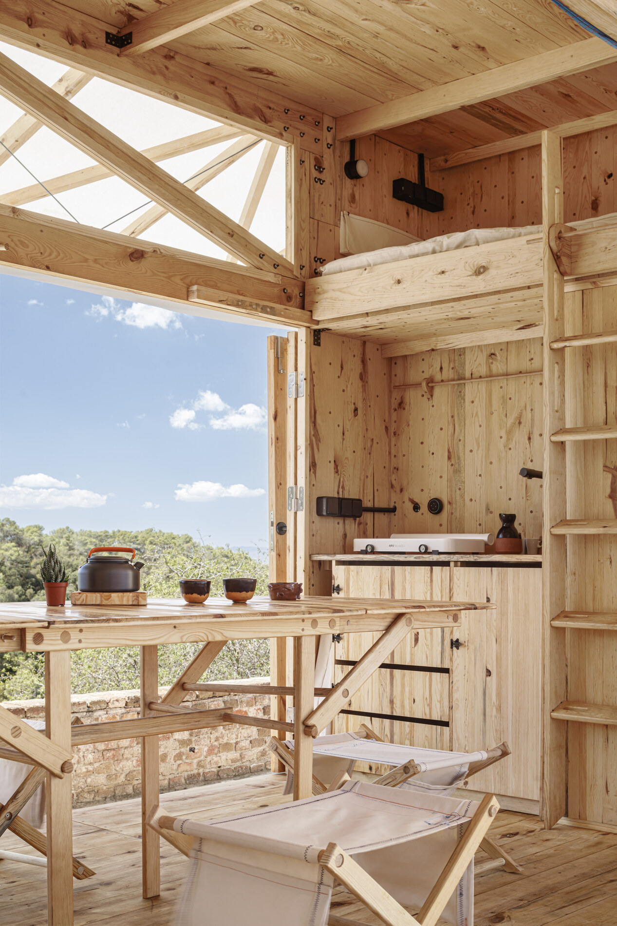 Interior — galley, fold-out table and the loft above.