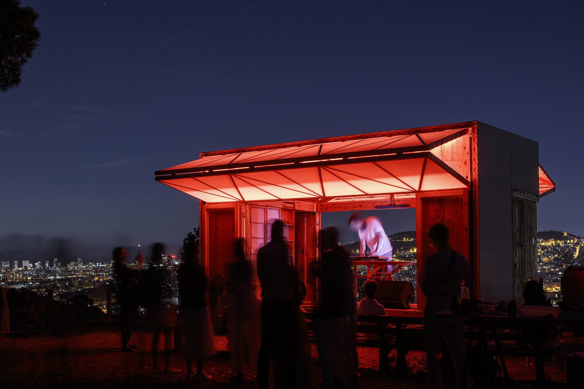 Lit for a night event on the ridge above the city.