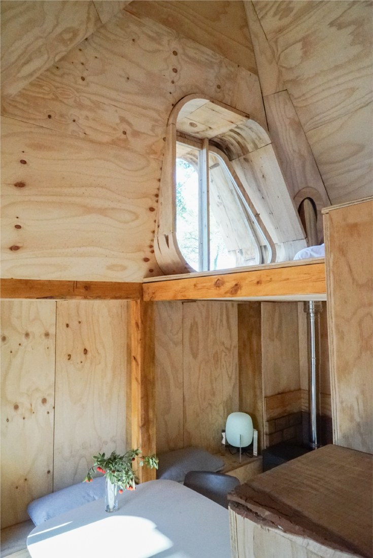 Completed interior with living space below and sleeping loft above.