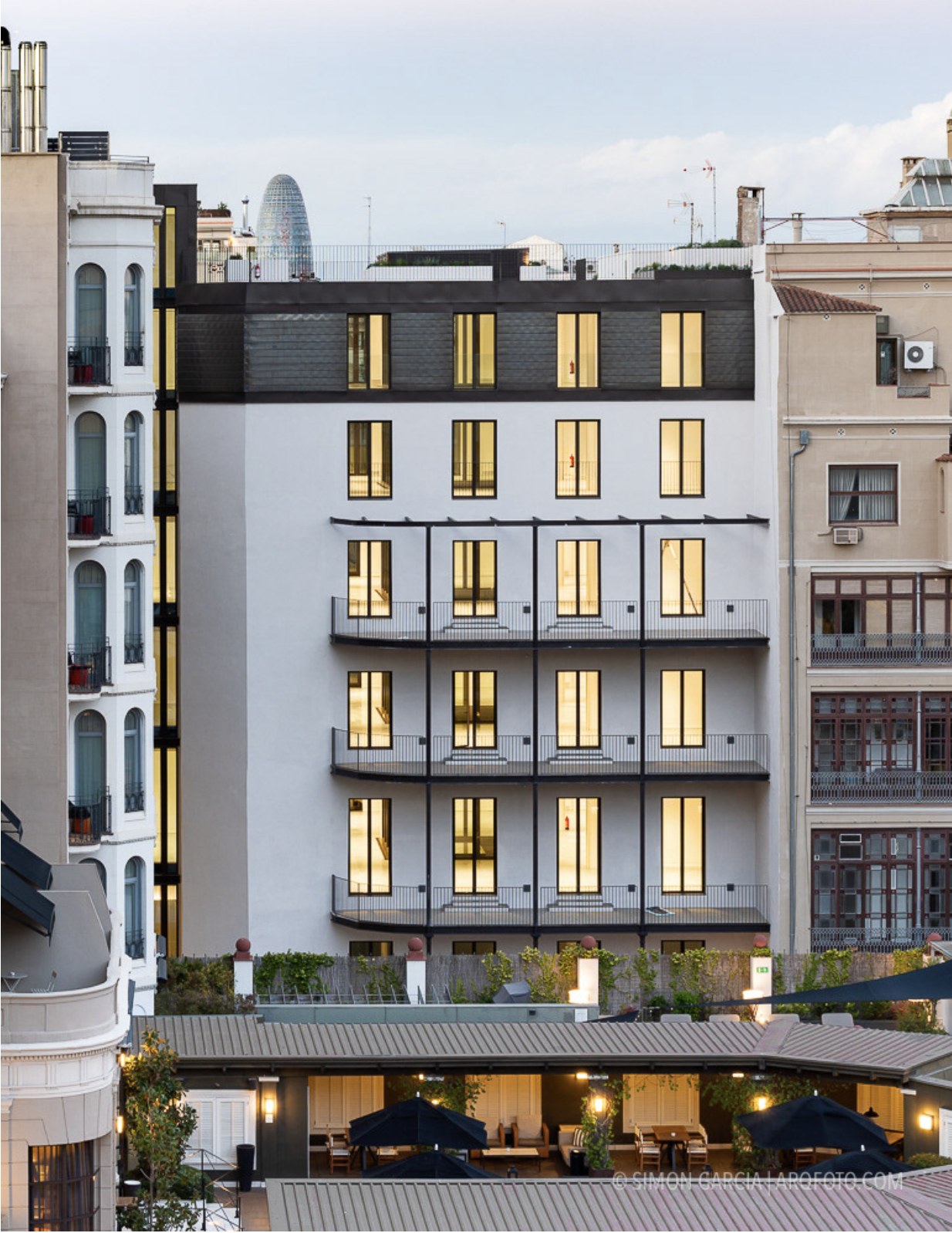 Claris 39 in Barcelona, pictured from the block's interior courtyard — vertical extensions are often combined with envelope and mobility upgrades.