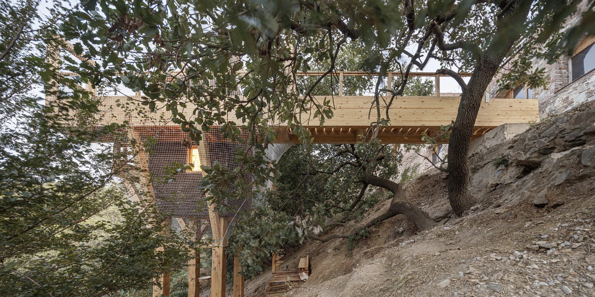 Engineering composite assemblies from smaller pieces permits lower-value wood to support large spans, like the 14m cantilevered bridge of FLORA by IAAC, pictured here.