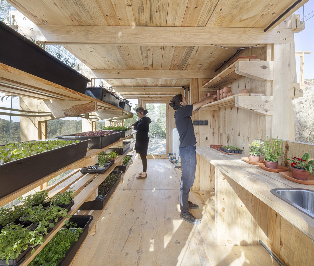 Tending the growing trays inside the prototype.