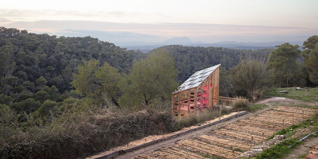 The greenhouse tower at sunset, above the valley.