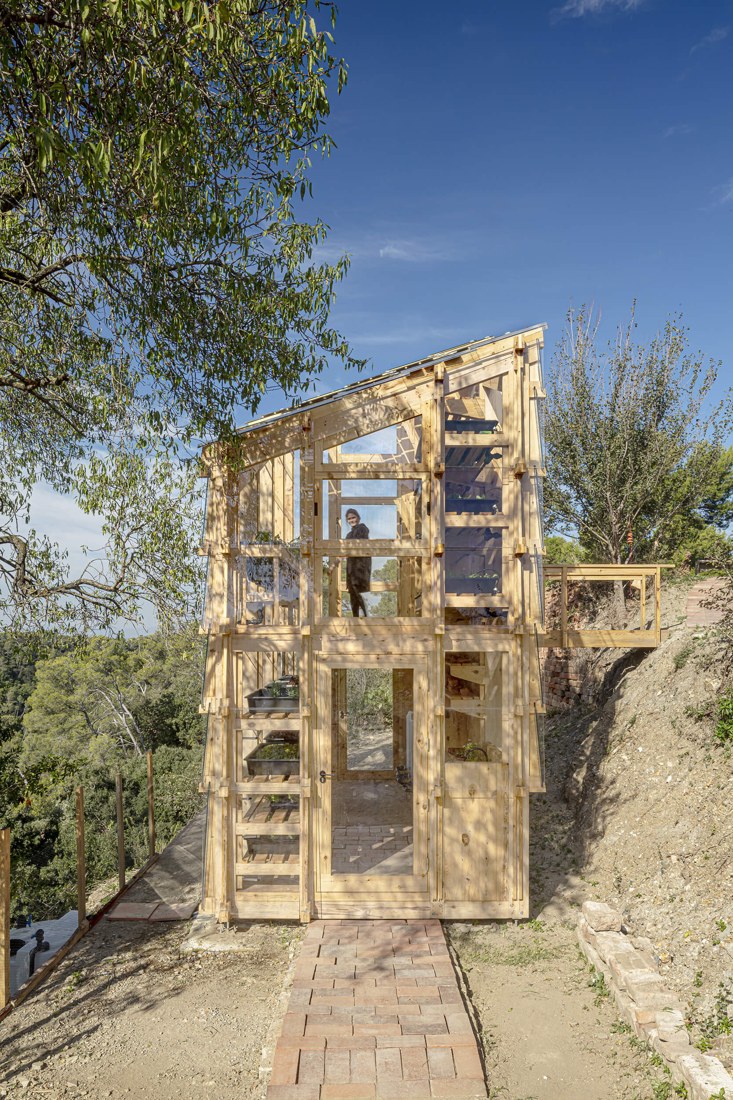 The tower connects terraced garden levels with multiple entry points.