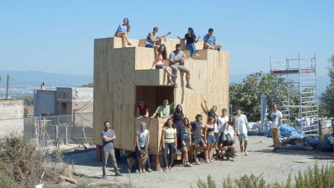 Student and staff team with the modular CLT structure completed off-site, prior to lifting into its final location.