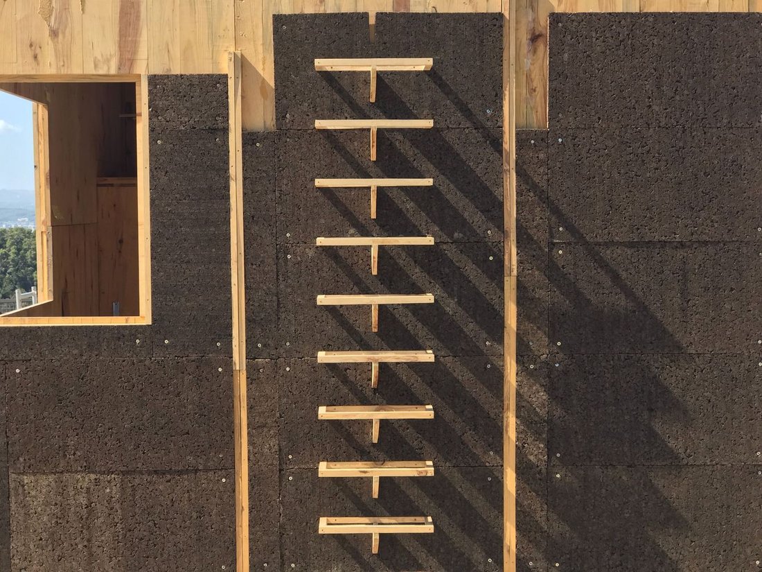 Structure clad with cork insulation prior to application of the rain screen.