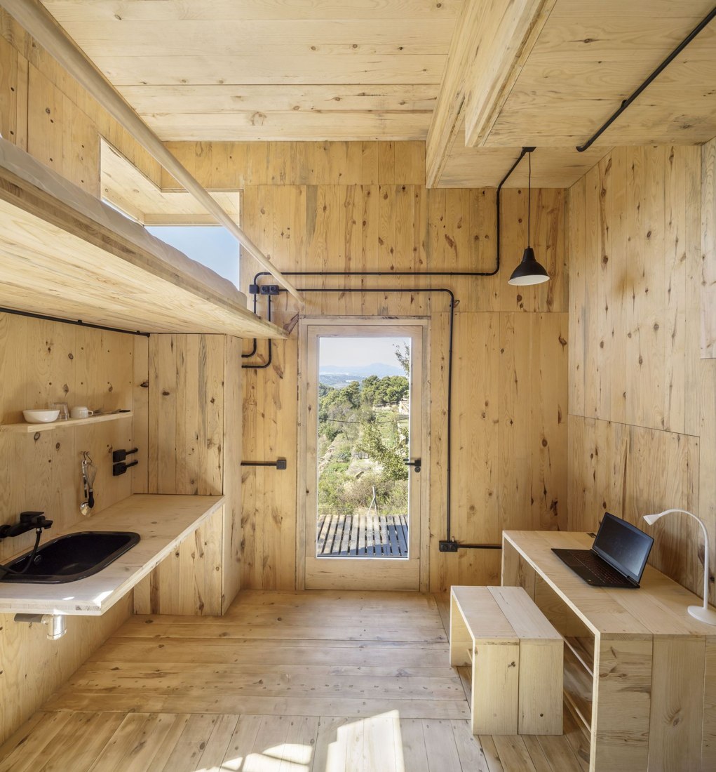 Interior — kitchen counter and desk by the entry.