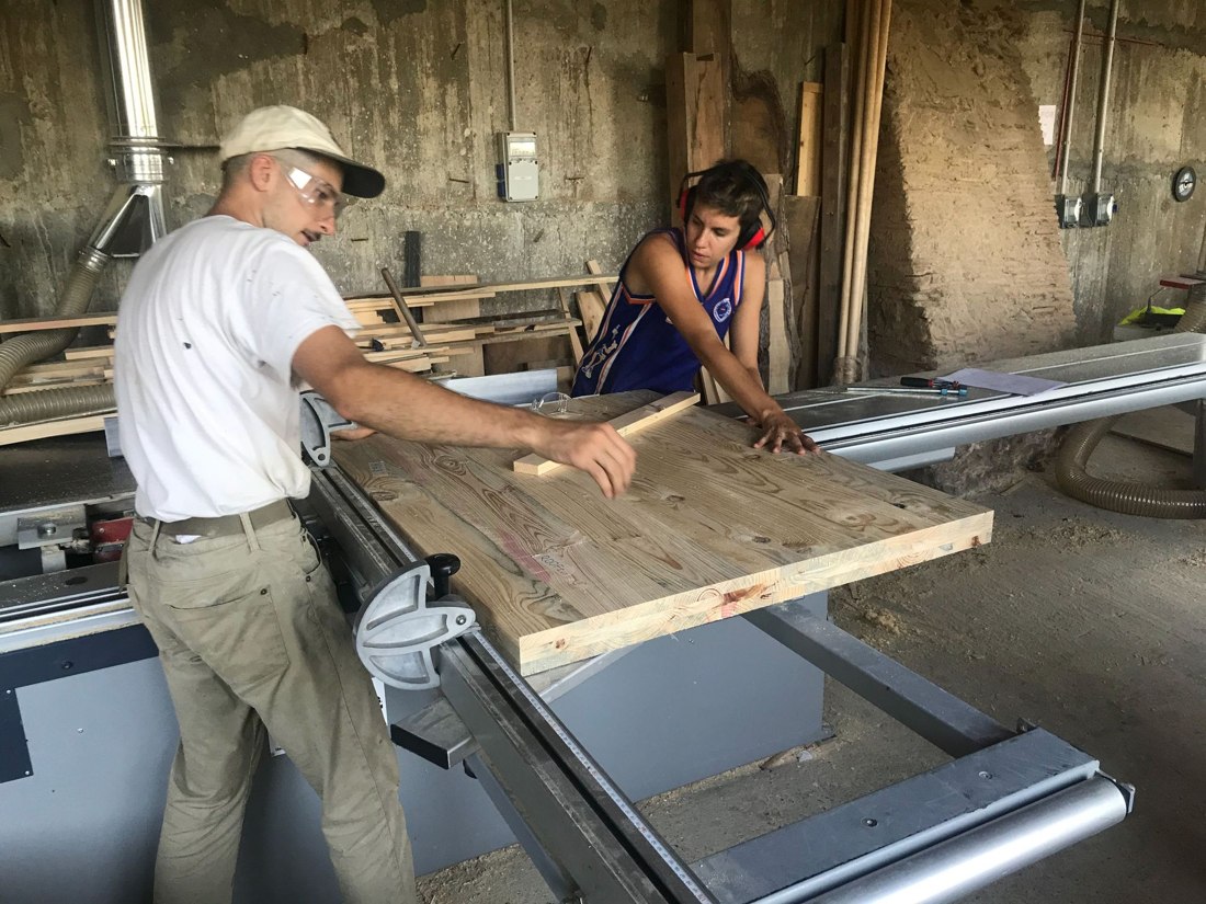 Students cutting panels on the table saw.