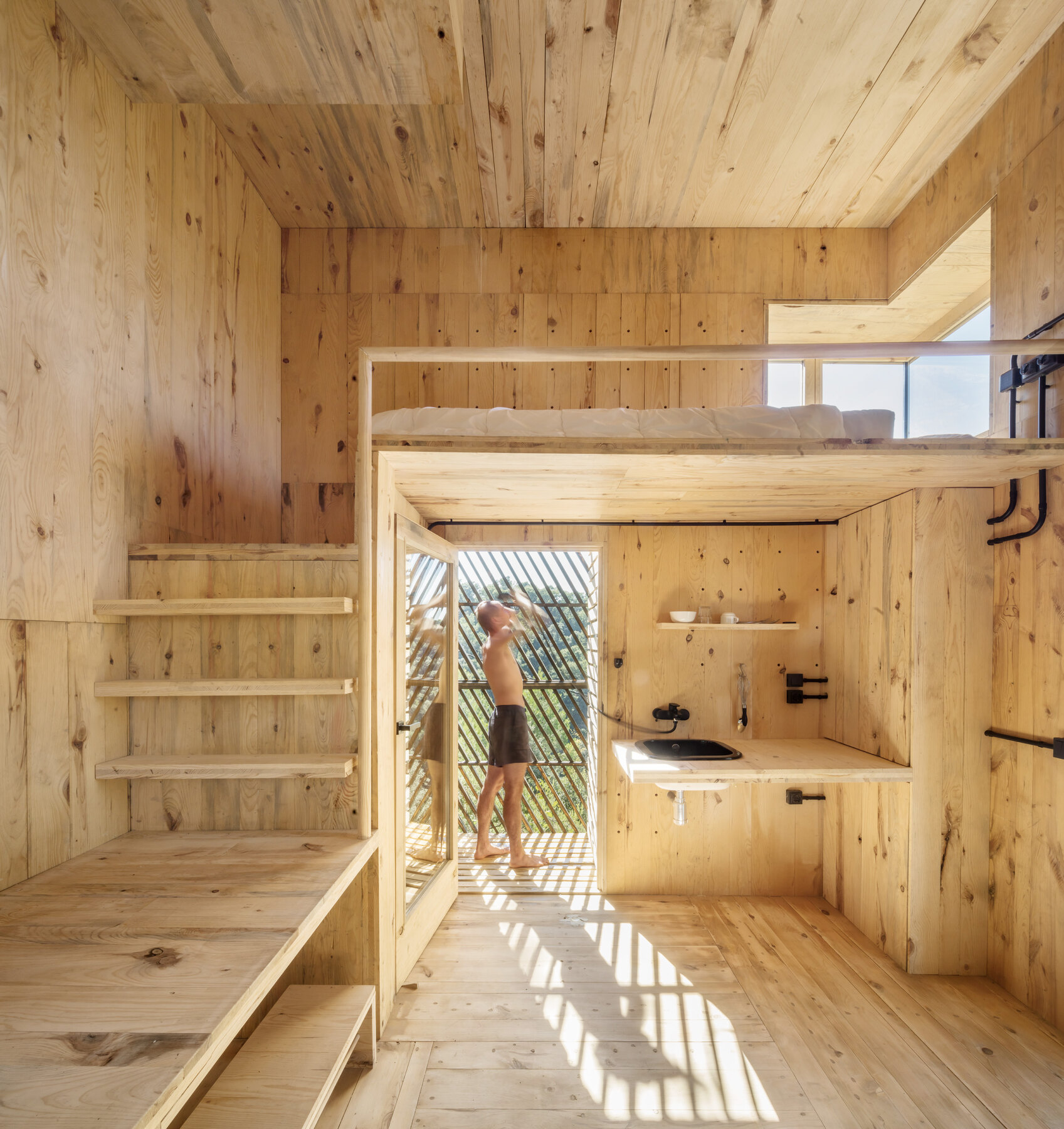 Interior — sleeping loft over the kitchen and work surface.